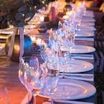 A beautifully set dinner table with candles and glassware, perfect for elegant events.